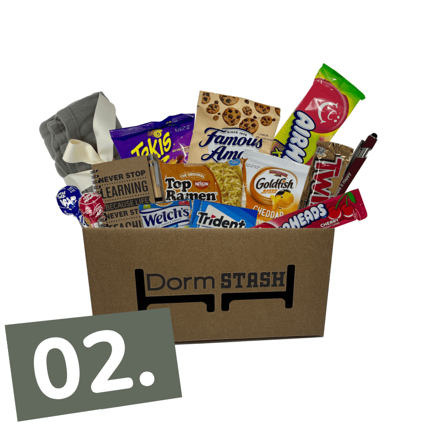 A cardboard box labeled "Dorm Stash" filled with snacks, cookies, candy, a pen, socks, and other small items; a "02." label appears in the corner.