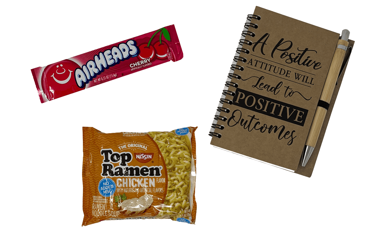 29 (1) A cherry Airheads candy, a pack of chicken-flavored Top Ramen, and a notebook with pen that says, "A positive attitude will lead to positive outcomes.